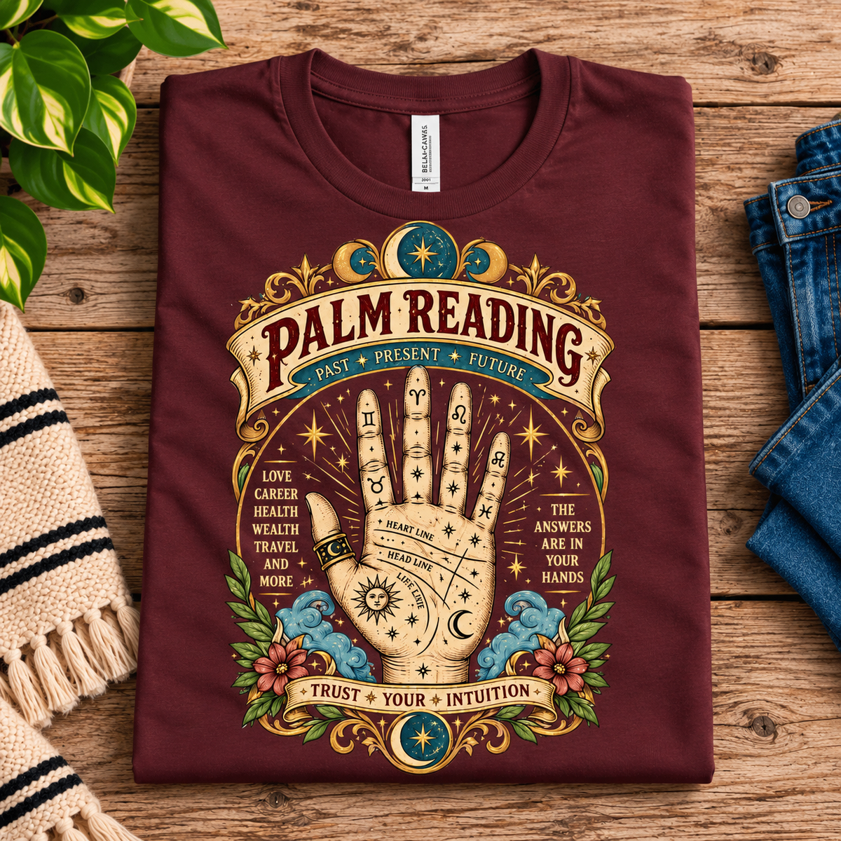 A folded mockup of Palm Reading retro mystical graphic t-shirt in maroon.
