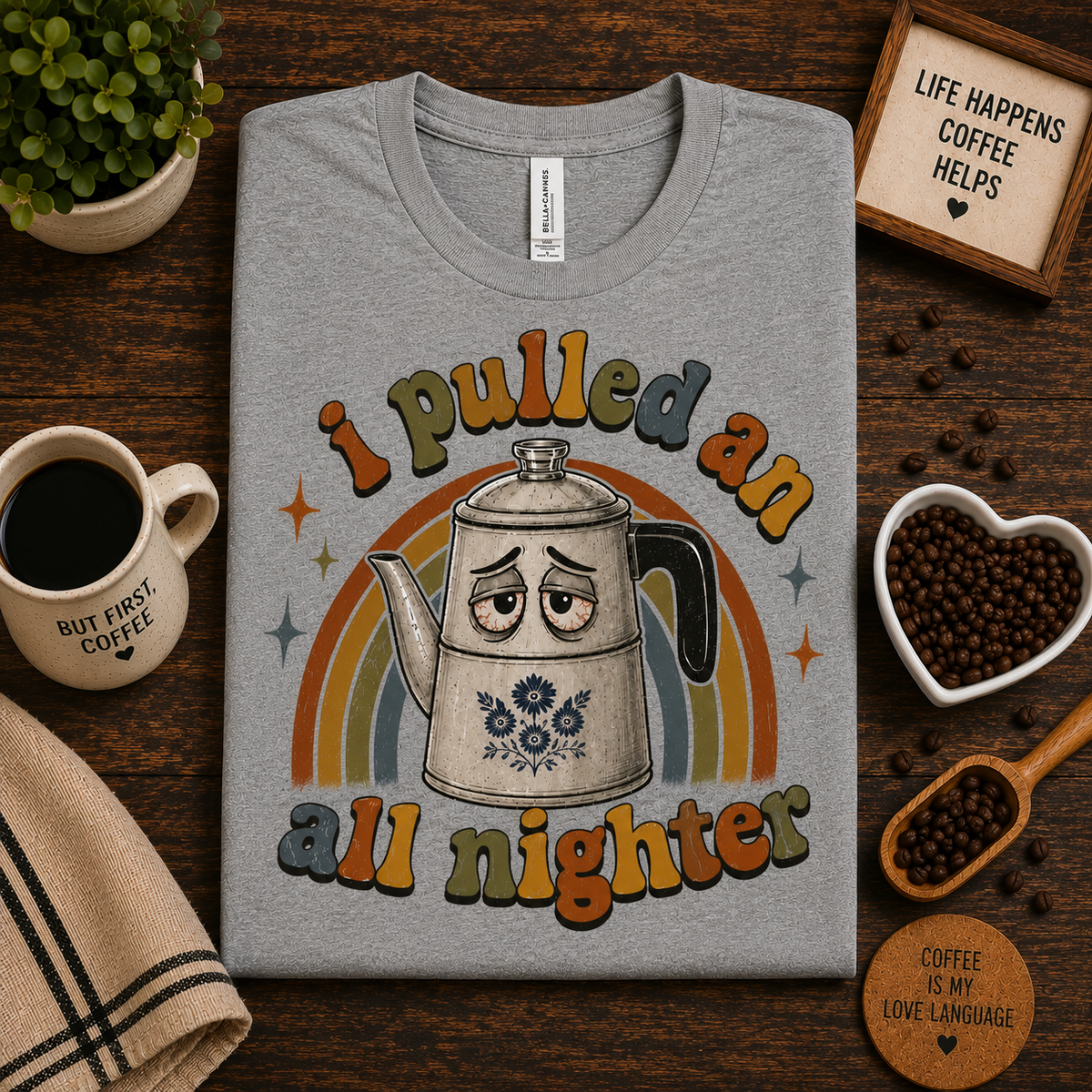 A folded mockup of All Nighter cute coffee graphic t-shirt in athletic heather.