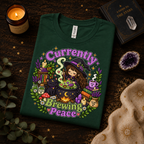 A folded mockup of Currently Brewing cute witchy  graphic t-shirt in evergreen.