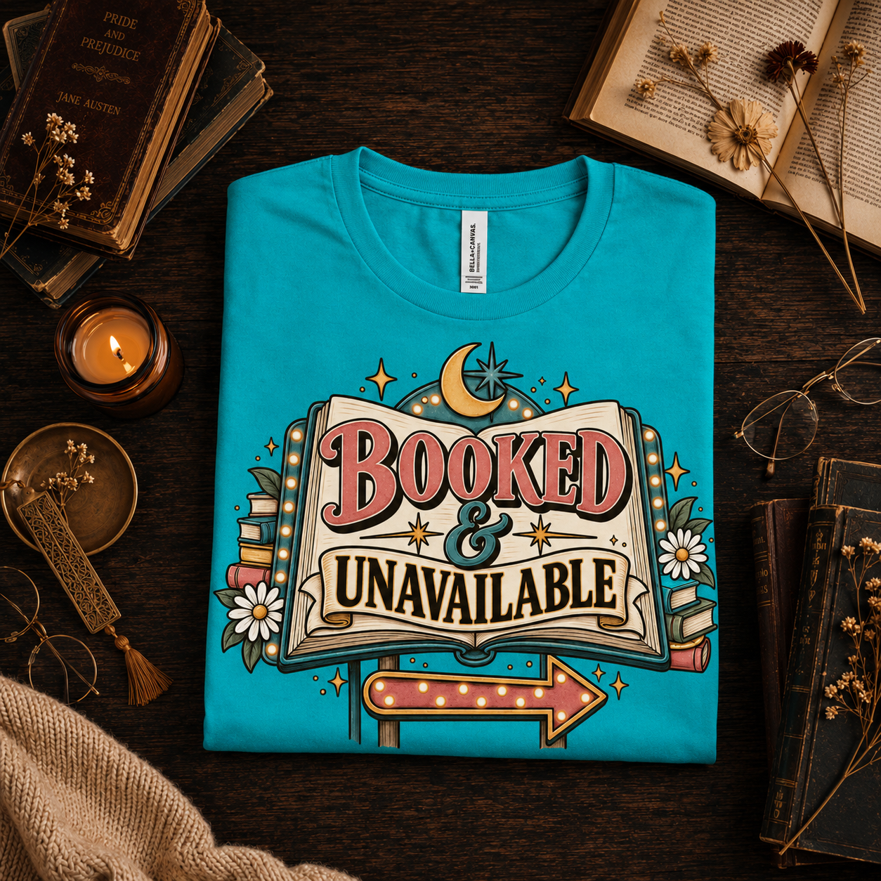 A folded mockup of Booked & Unavailable graphic t-shirt in heather sea green.