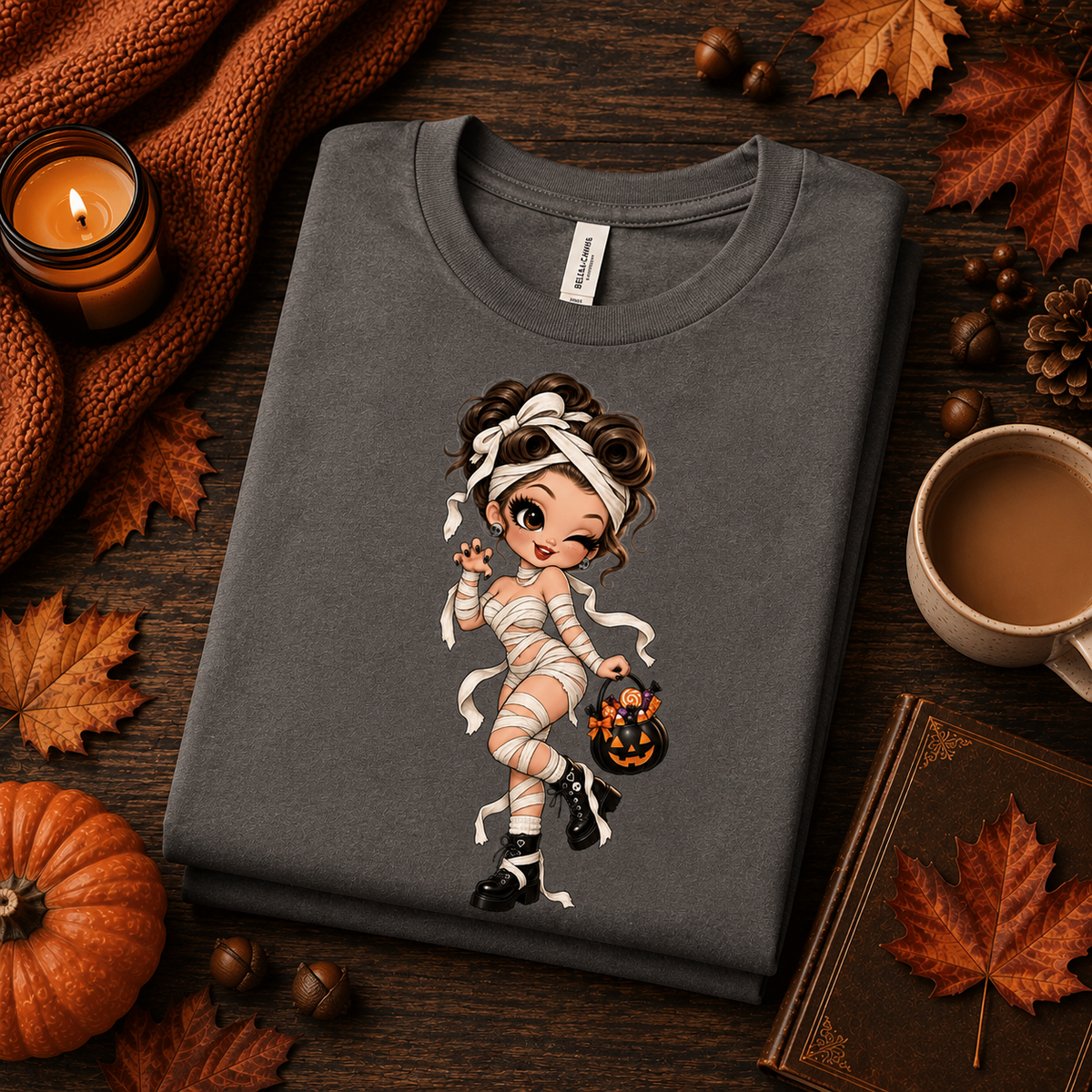A folded mockup of Mummy Mimi halloween pinup graphic t-shirt in asphalt.