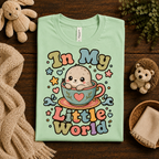 A folded mockup of In My Little World cute animal graphic t-shirt in mint.