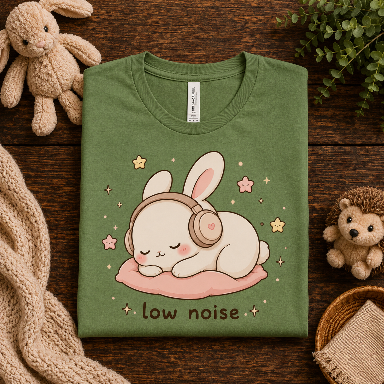 A folded mockup of Low Noise Bunny cute animal graphic t-shirt in leaf.