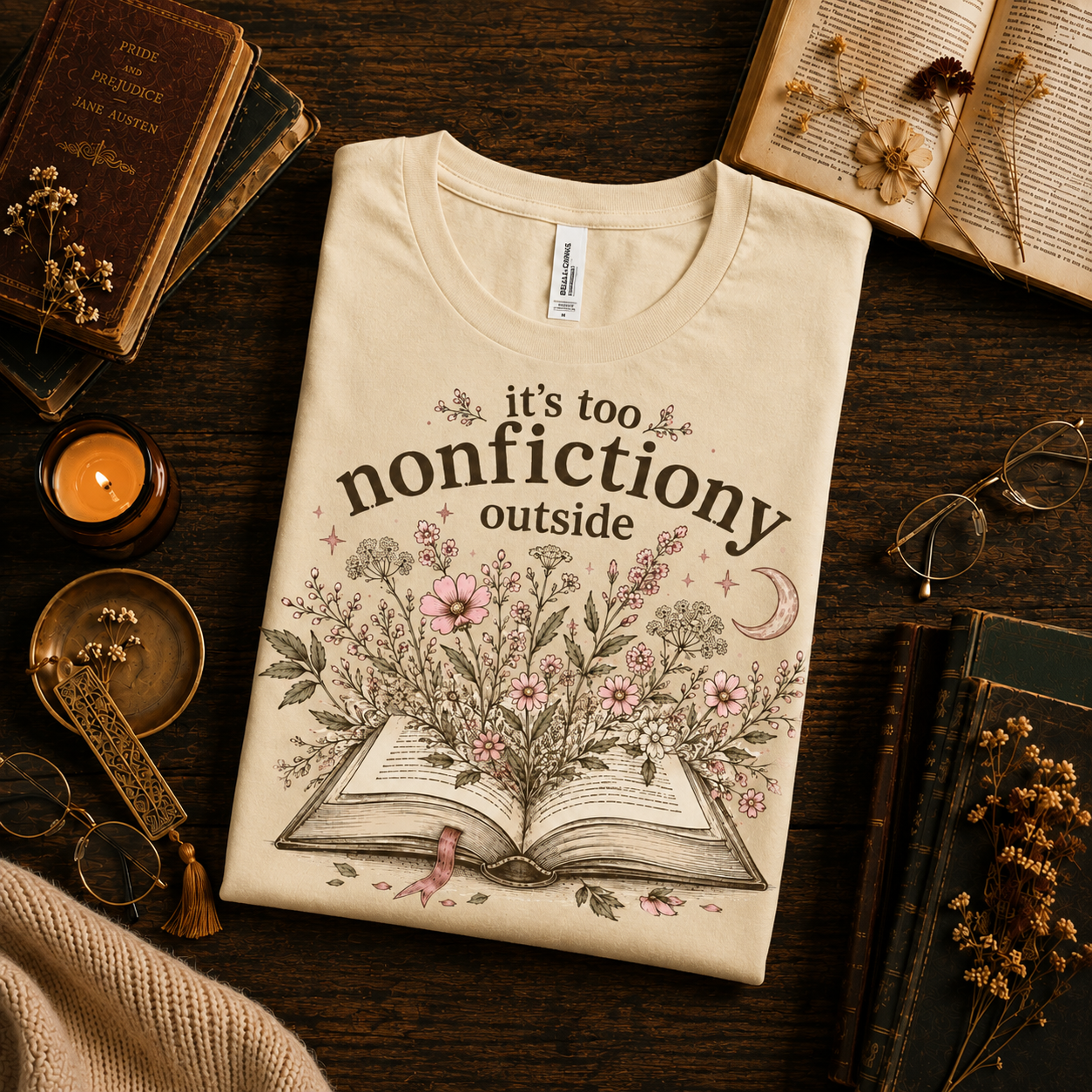 A folded mockup of Nonfictiony whimsical book graphic t-shirt in natural.