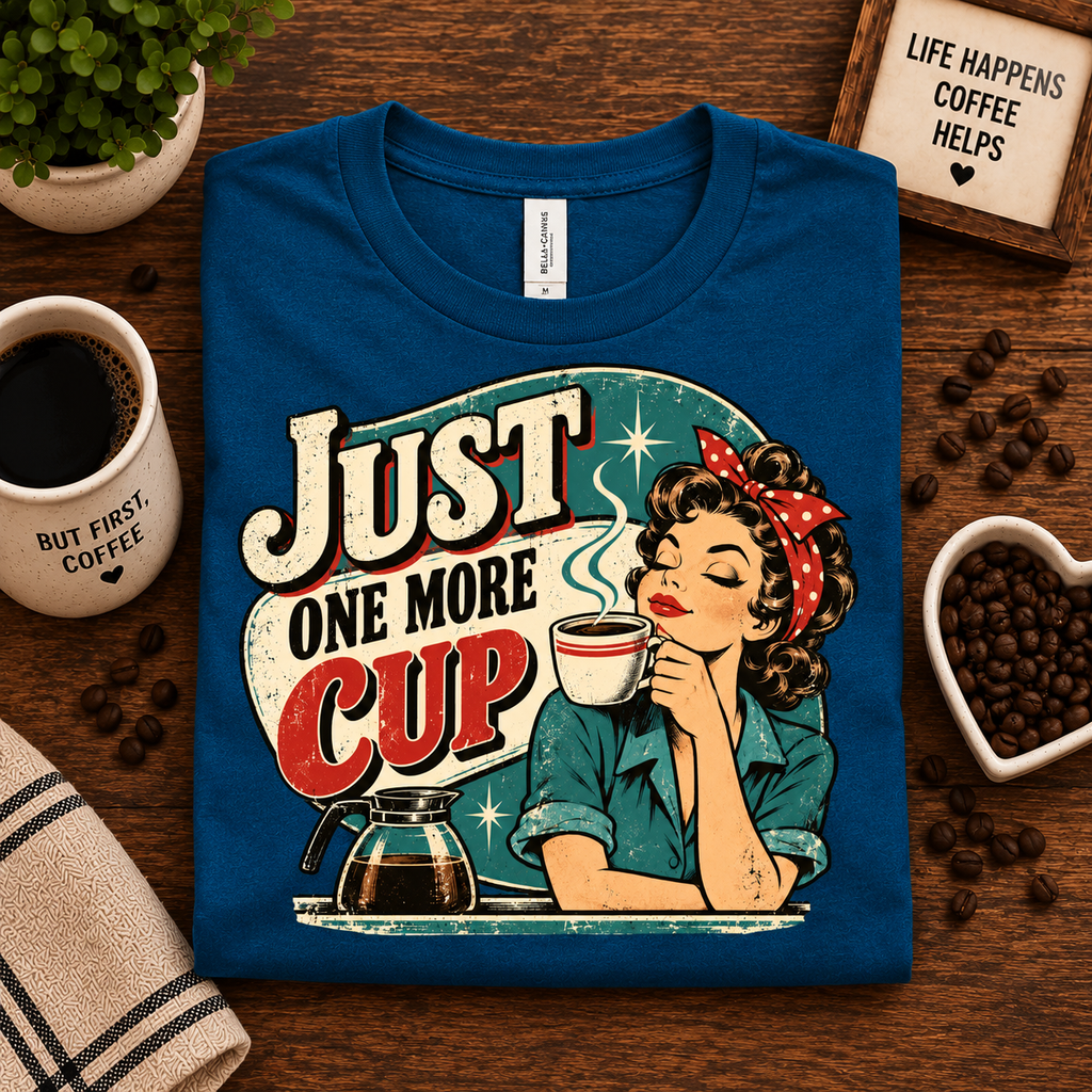 A folded mockup of Just One More retro coffee graphic t-shirt in deep teal.