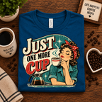 A folded mockup of Just One More retro coffee graphic t-shirt in deep teal.