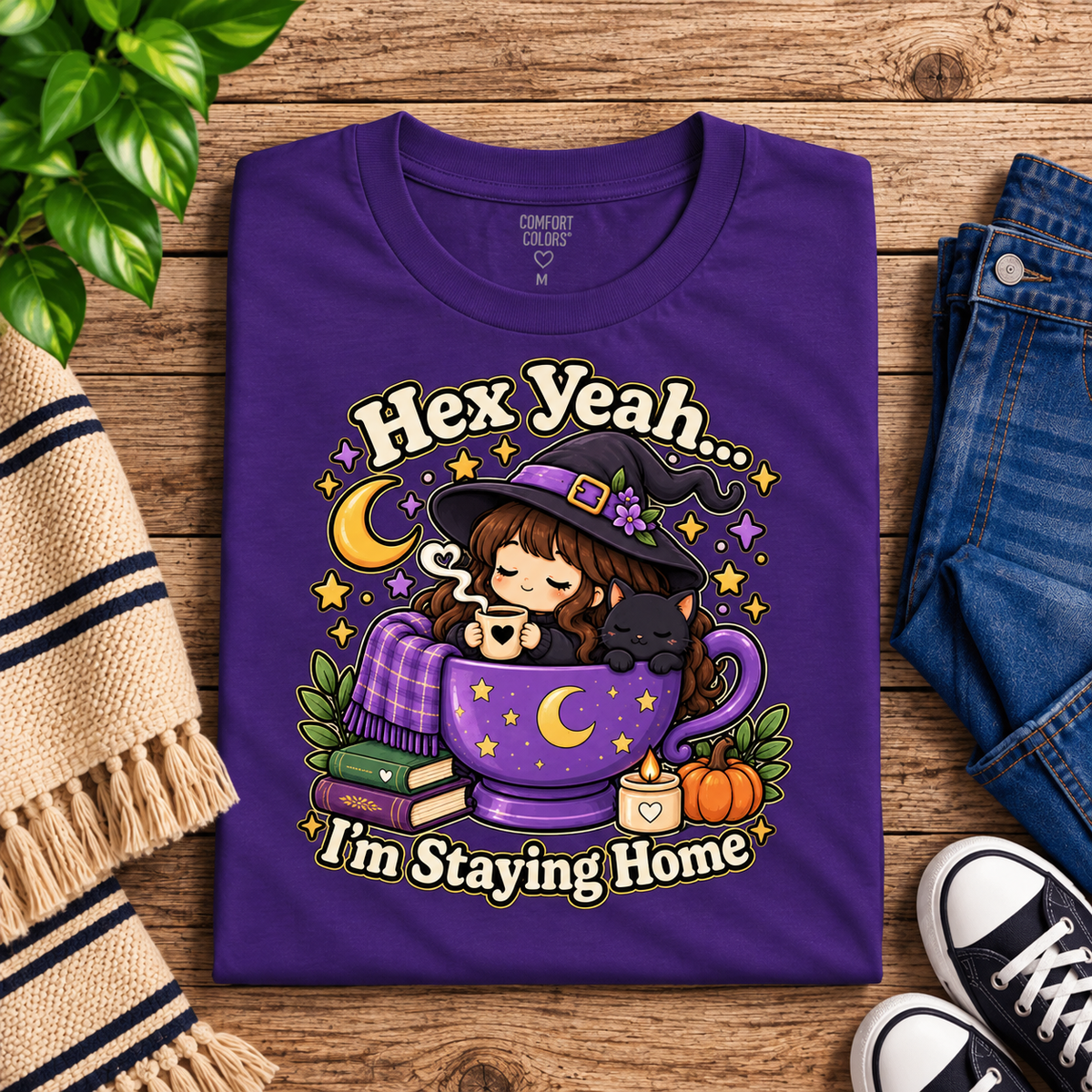 A folded mockup of Hex Yeah witchy celestial graphic t-shirt in team purple.