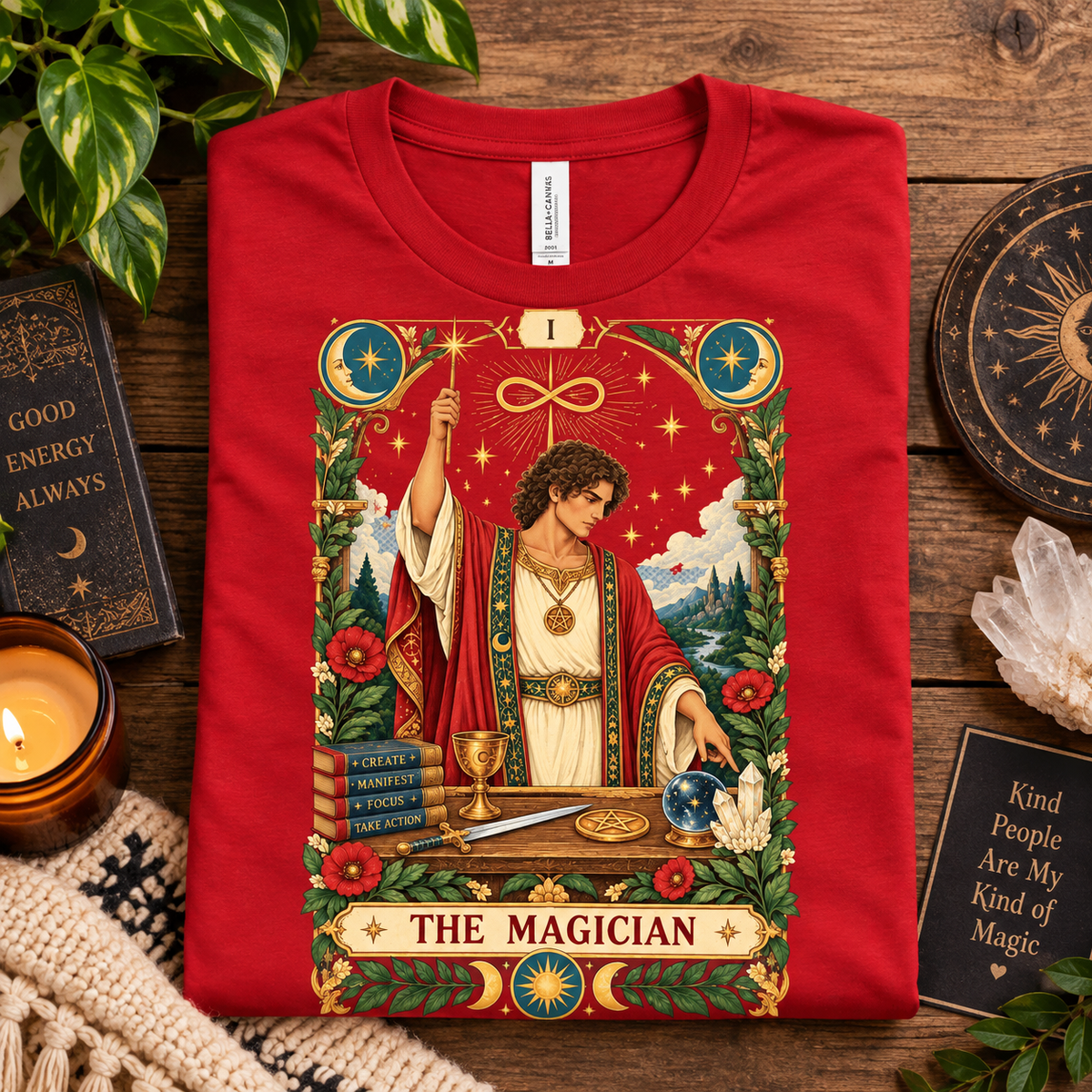 A folded mockup of The Magician tarot card graphic t-shirt in red.