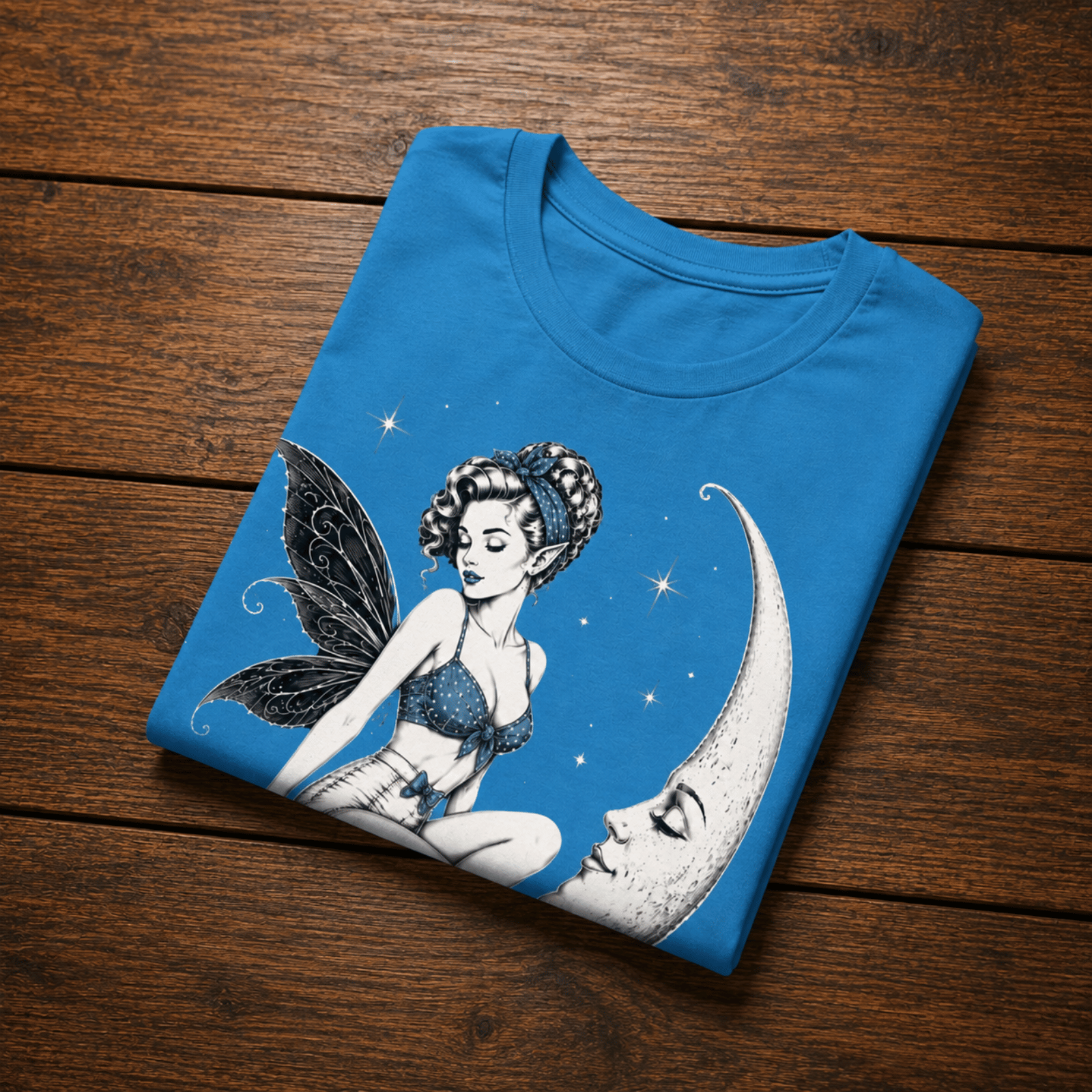 An aqua Moonlit Fairy pinup graphic t-shirt in a folded mockup.