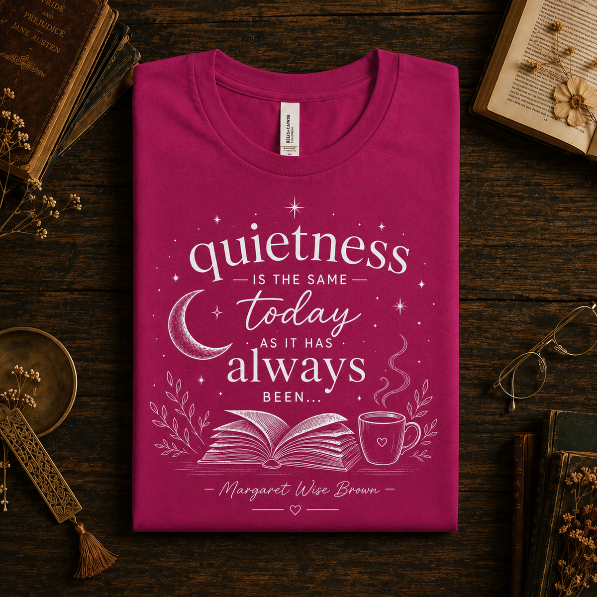 A folded mockup of Quietness Today book quote graphic t-shirt in berry.
