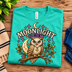A folded mockup of Moonlight Society cute celestial graphic t-shirt in heather sea green.