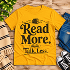 Talk Less funny book graphic t-shirt cozy flat lay in gold.