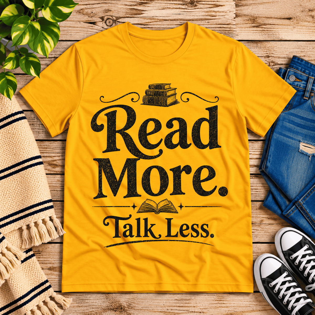 Talk Less funny book graphic t-shirt cozy flat lay in gold.