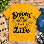 Sippin' on Life cute coffee graphic t-shirt cozy flat lay in gold.