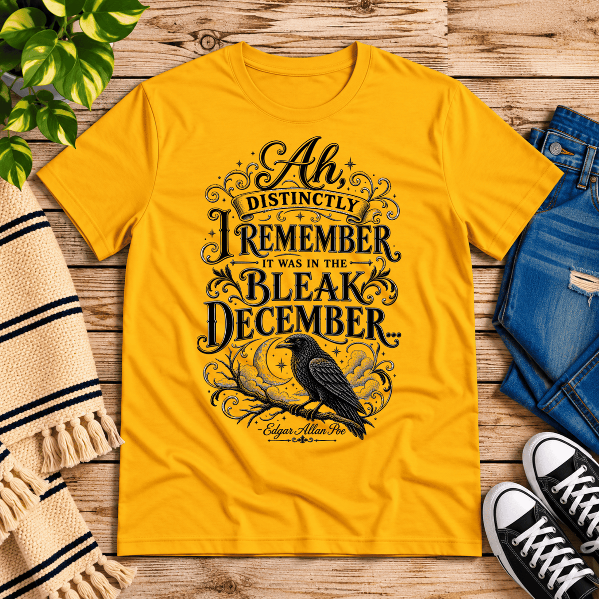 Bleak December book quote graphic t-shirt cozy flat lay in gold.