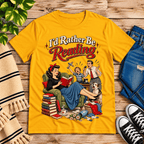A cozy flat lay mockup of I'd Rather Be retro book graphic t-shirt in gold.