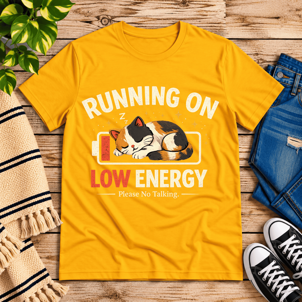 Low Energy Cat cute animal graphic t-shirt cozy flat lay in gold.
