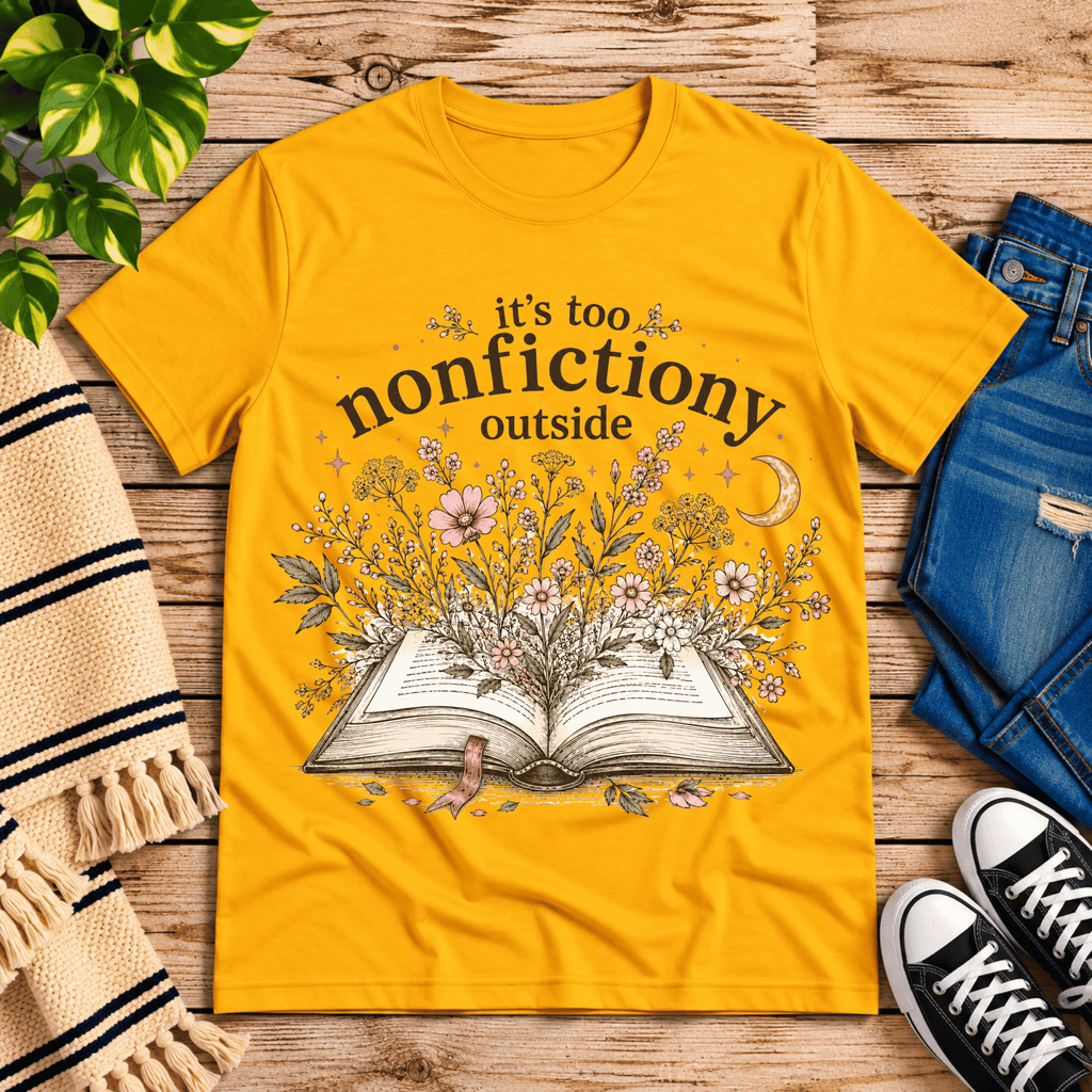 Nonfictiony whimsical book graphic t-shirt cozy flat lay in gold.