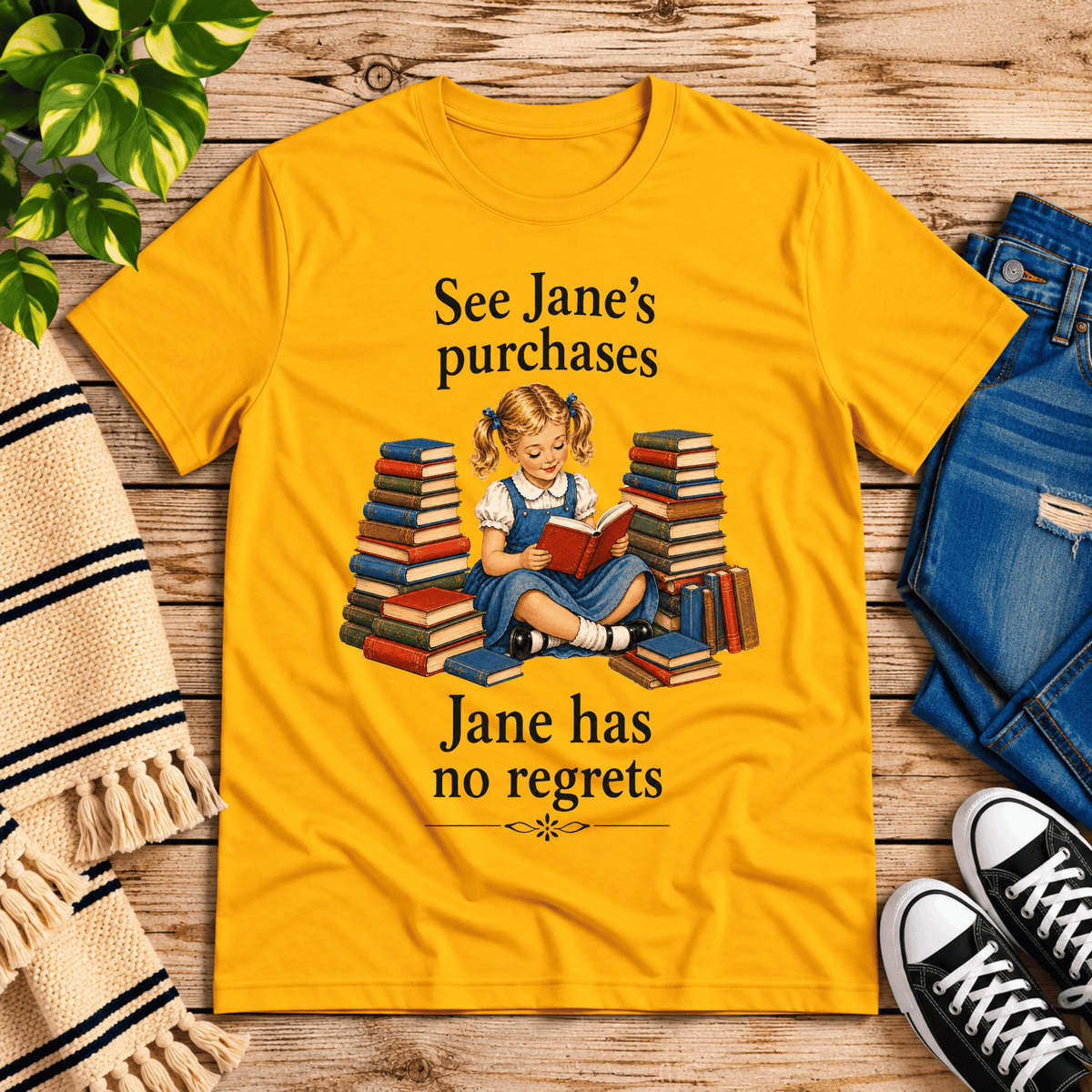 See Jane's Purchases vintage book graphic t-shirt cozy flat lay in gold.