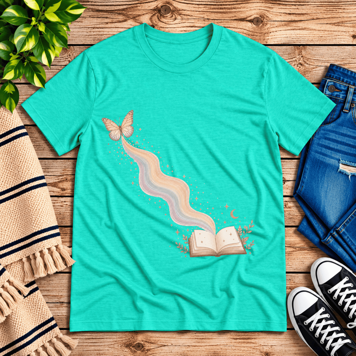Rainbow Book whimsical book graphic t-shirt cozy flat lay in heather sea green.