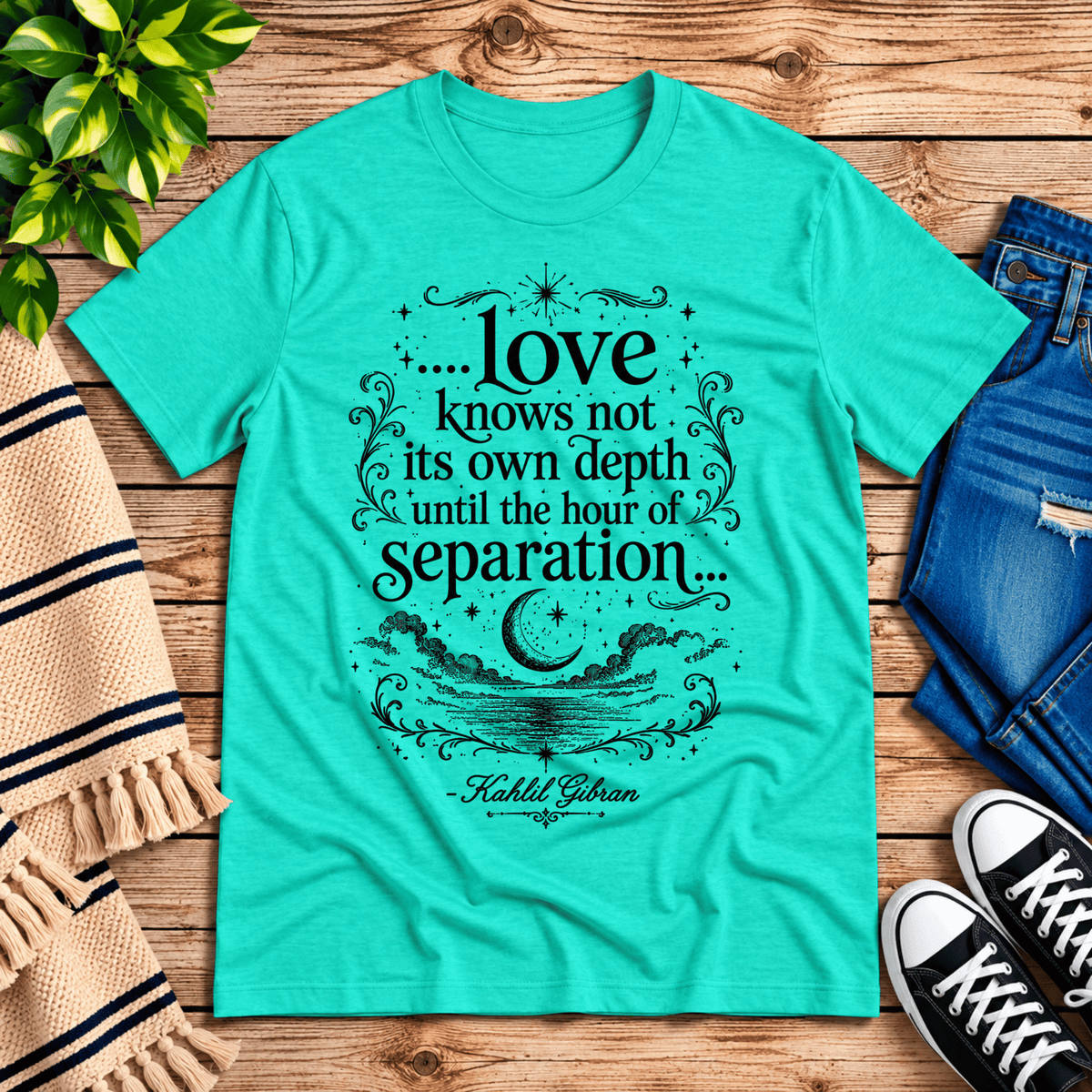 Love Knows Not book quote graphic t-shirt cozy flat lay in heather sea green.