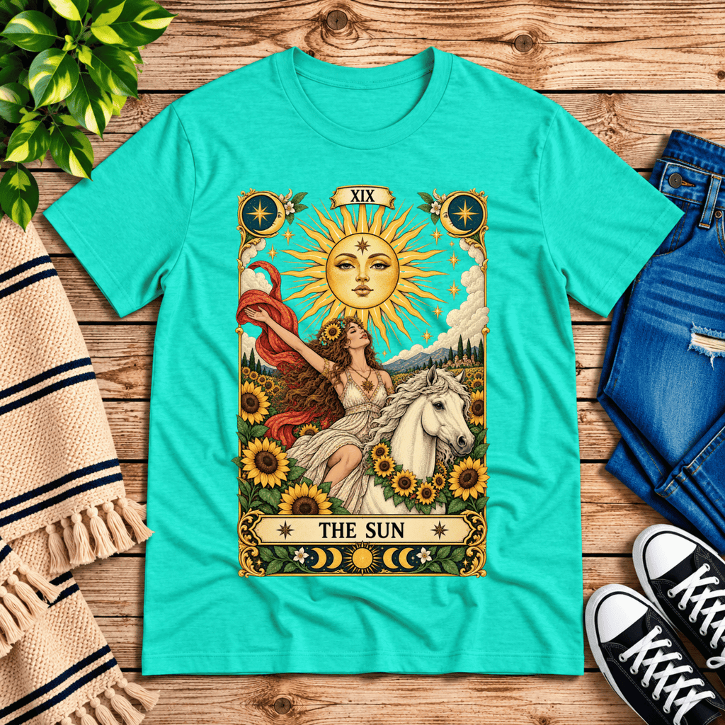 The Sun tarot card mystical graphic t-shirt cozy flat lay in heather sea green.