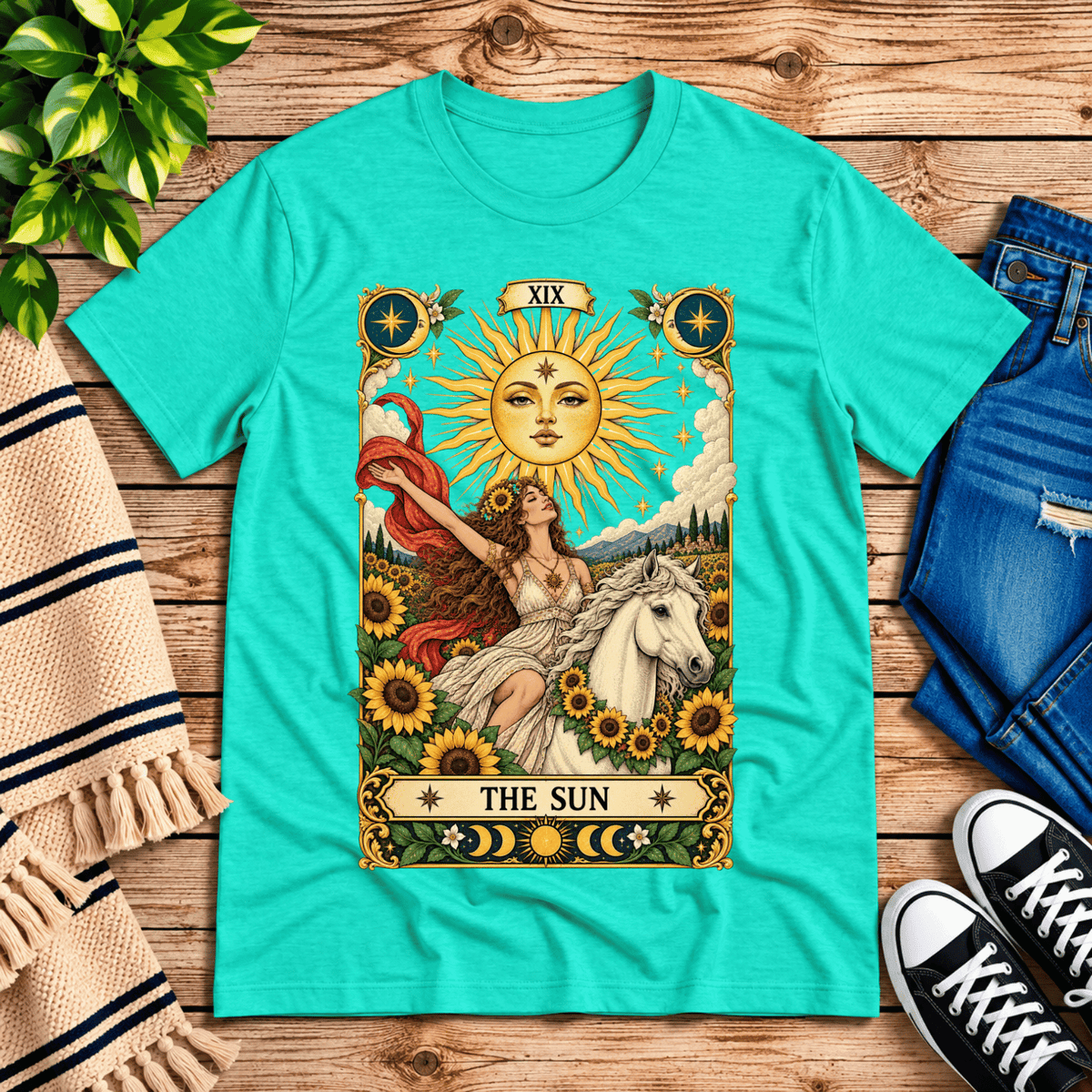 The Sun tarot card mystical graphic t-shirt cozy flat lay in heather sea green.