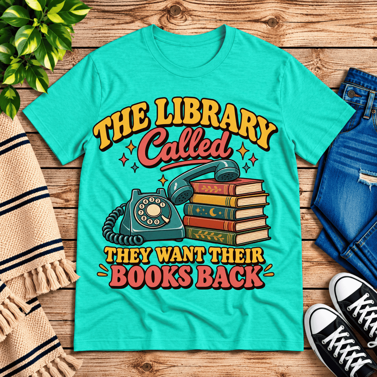 The Library Called book lovers graphic t-shirt cozy flat lay in heather sea green.