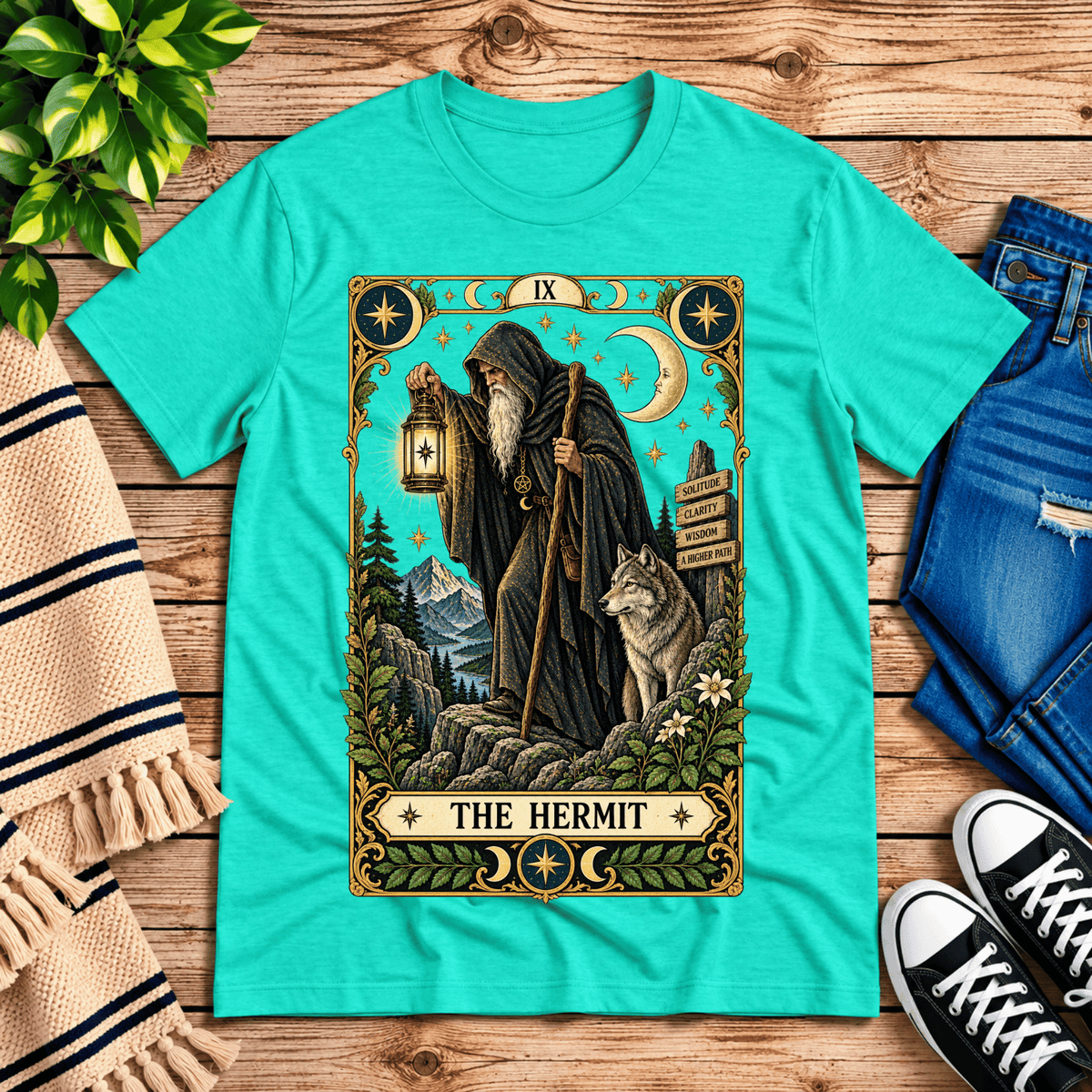 The Hermit tarot card graphic t-shirt cozy flat lay in heather sea green.