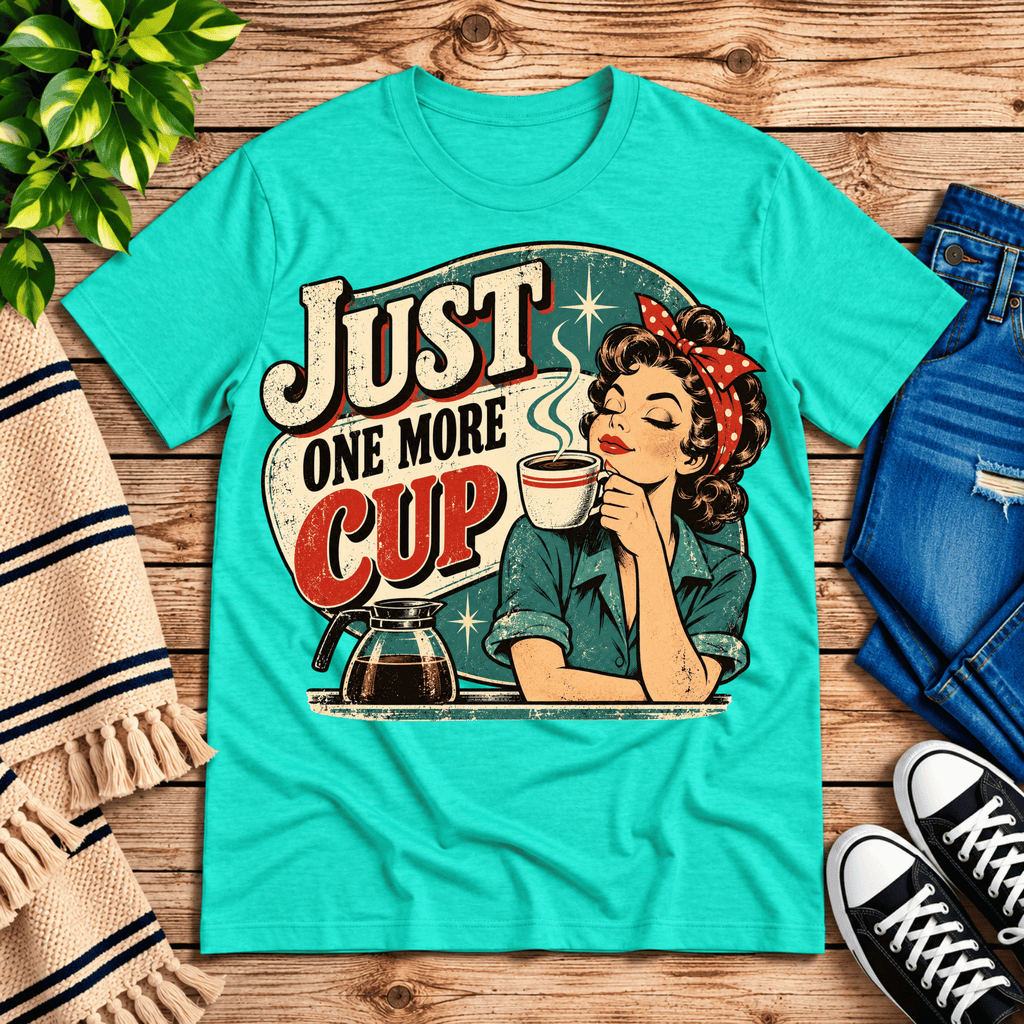 Just One More retro coffee graphic t-shirt cozy flat lay in heather sea green.
