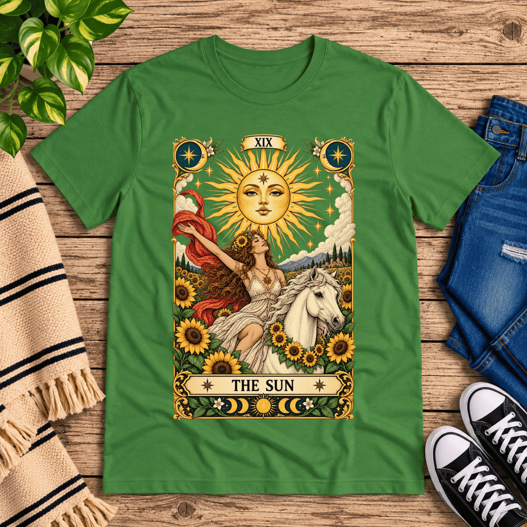 The Sun tarot card mystical graphic t-shirt cozy flat lay in leaf.