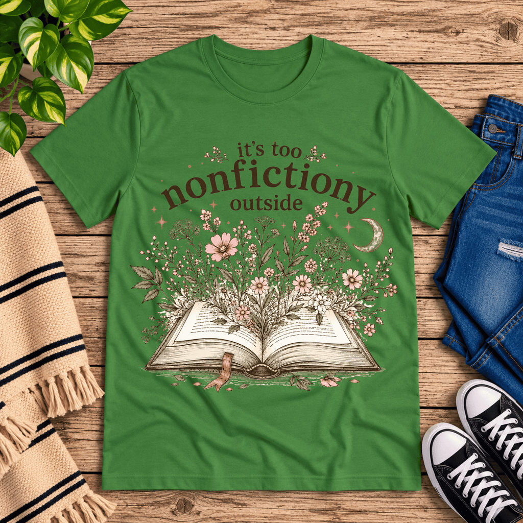 Nonfictiony whimsical book graphic t-shirt cozy flat lay in leaf.