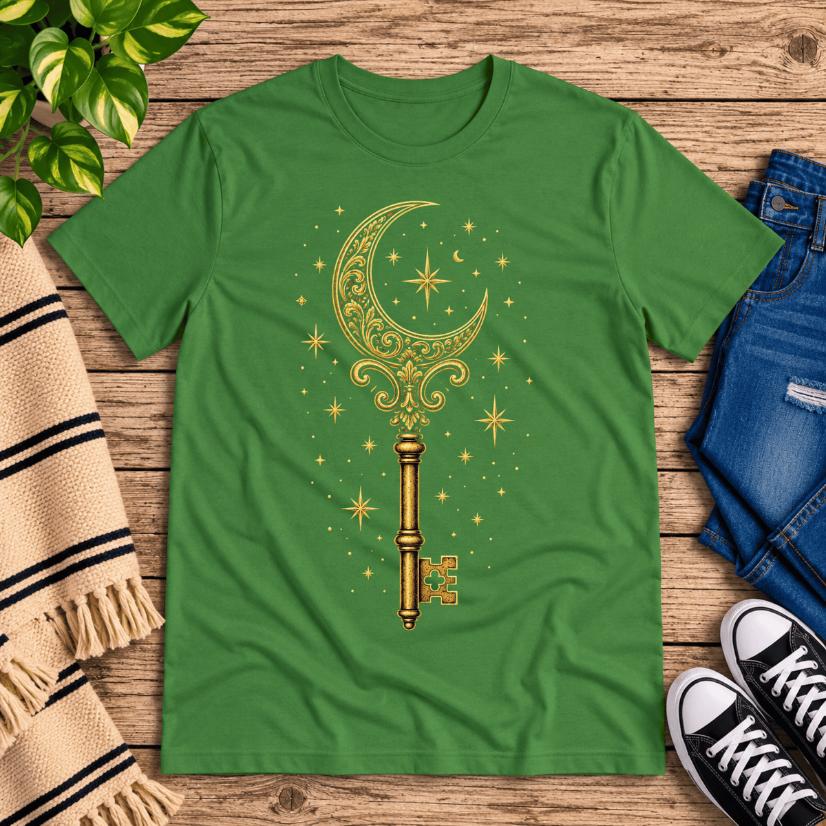 Moonlight Key whimsical celestial graphic t-shirt cozy flat lay in leaf.