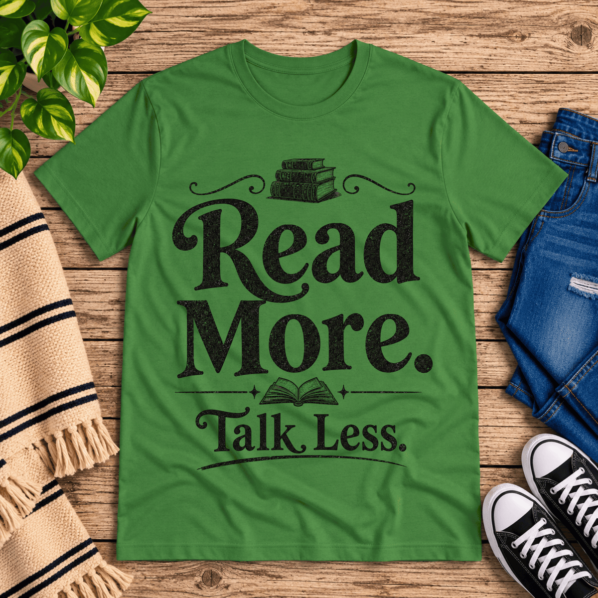 Talk Less funny book graphic t-shirt cozy flat lay in leaf.