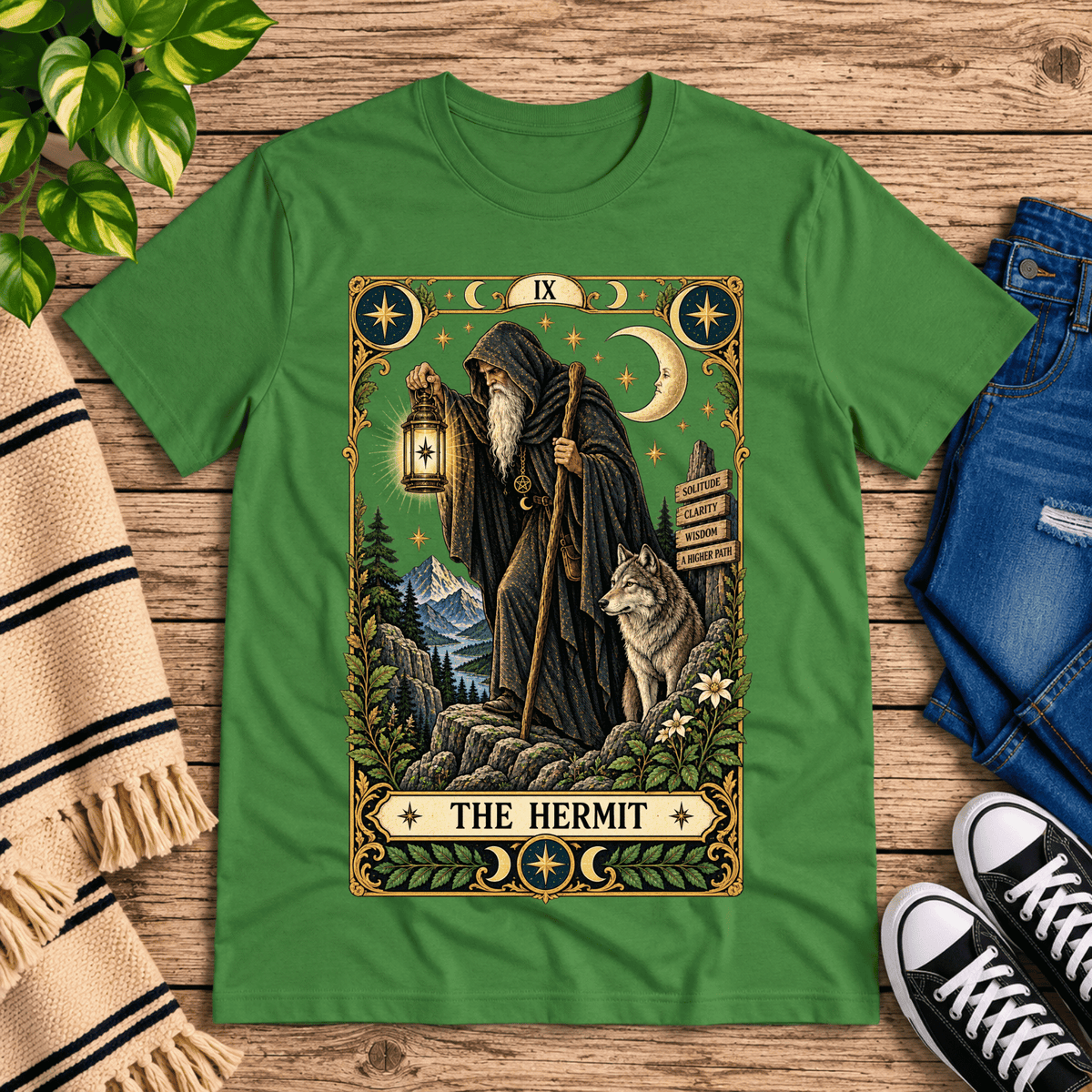 The Hermit tarot card graphic t-shirt cozy flat lay in leaf.