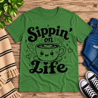 Sippin' on Life cute coffee graphic t-shirt cozy flat lay in leaf.