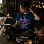 A woman wearing a deep teal Magic First cute celestial graphic t-shirt reading a book.