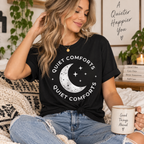 A woman wearing a vintage black Quiet Comforts celestial graphic t-shirt.