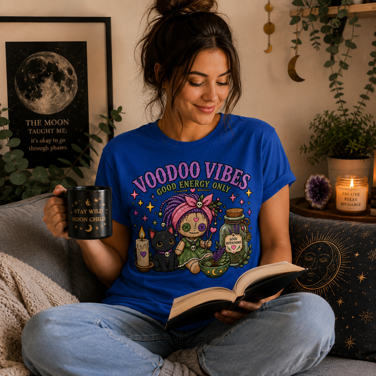 A woman wearing a true royal Voodoo Vibes cute witchy graphic t-shirt reading a book.