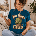A woman wearing a deep teal No Hugs Club funny cactus graphic t-shirt drinking coffee.
