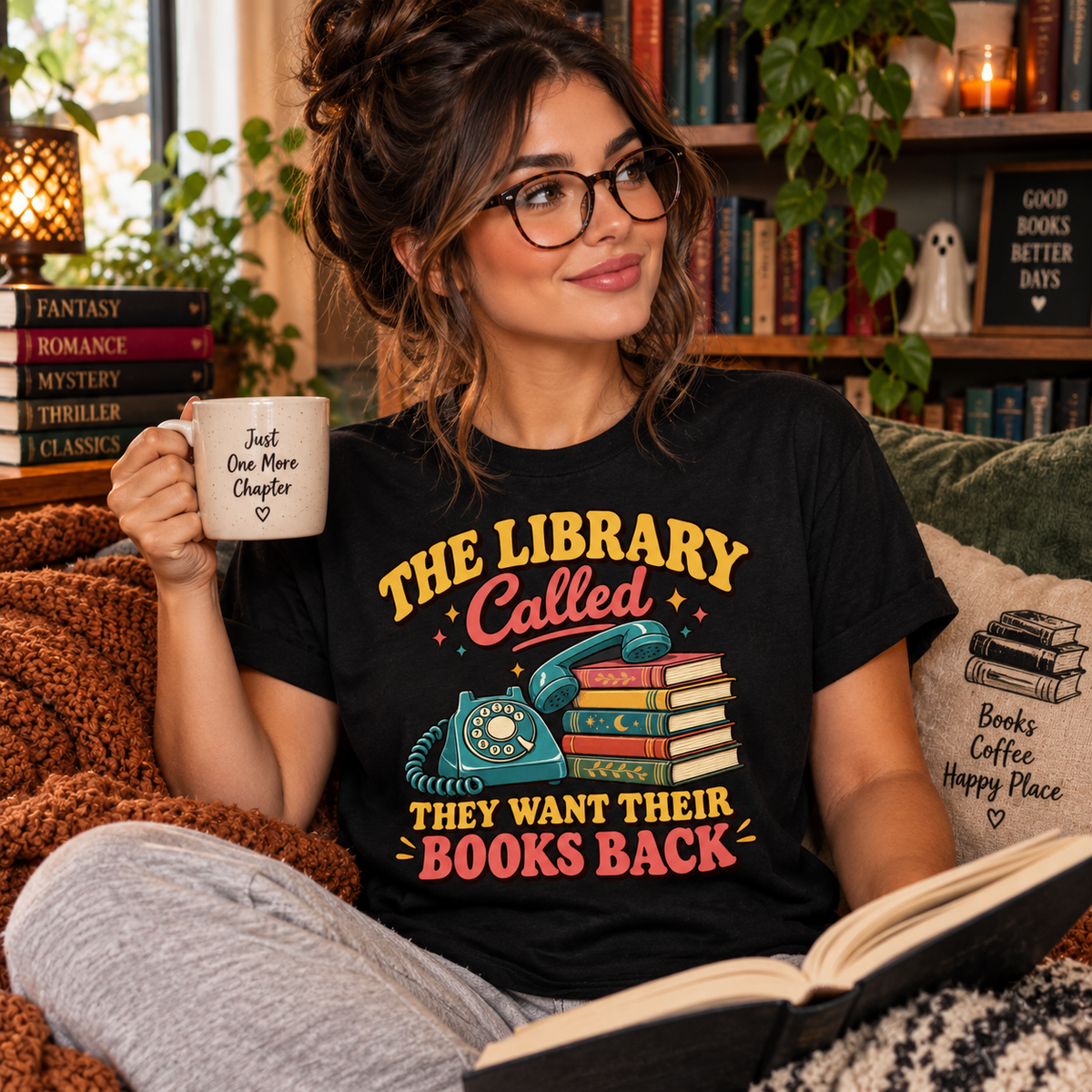A woman wearing a vintage black The Library Called book lovers graphic t-shirt white reading.