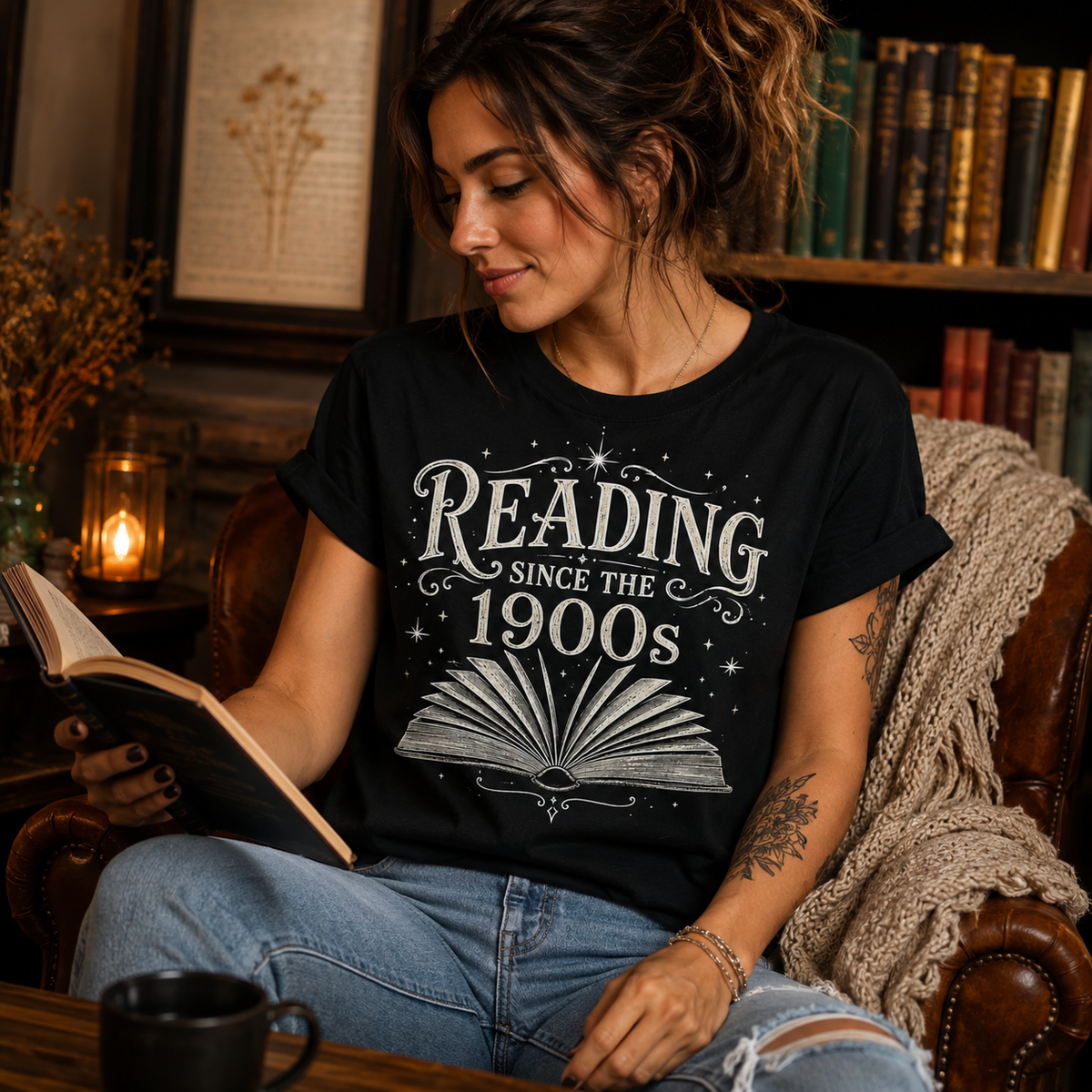 A woman wearing a vintage black Reading Since funny book graphic t-shirt reading a book.
