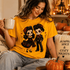 A woman wearing a gold Mr. & Mrs. halloween pinup graphic t-shirt drinking coffee.