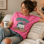 A woman wearing a charity pink Chronic Chiller funny introvert graphic t-shirt drinking coffee.