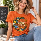 A woman wearing a burnt orange Good Luck Gold cute celestial graphic t-shirt.