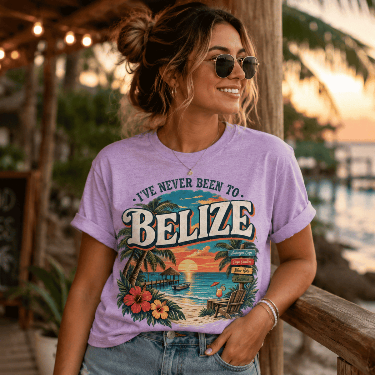 A woman wearing a lilac Belize funny introvert graphic t-shirt near a beach.