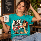 A woman wearing a heather sea green Just One More retro coffee graphic t-shirt.