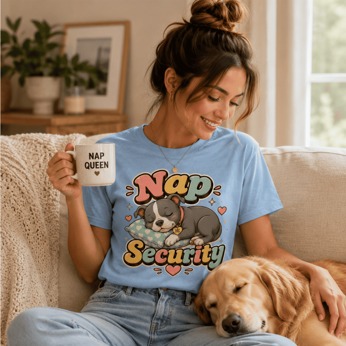 A woman wearing a baby blue Nap Security cute animal graphic t-shirt drinking coffee and petting her dog.