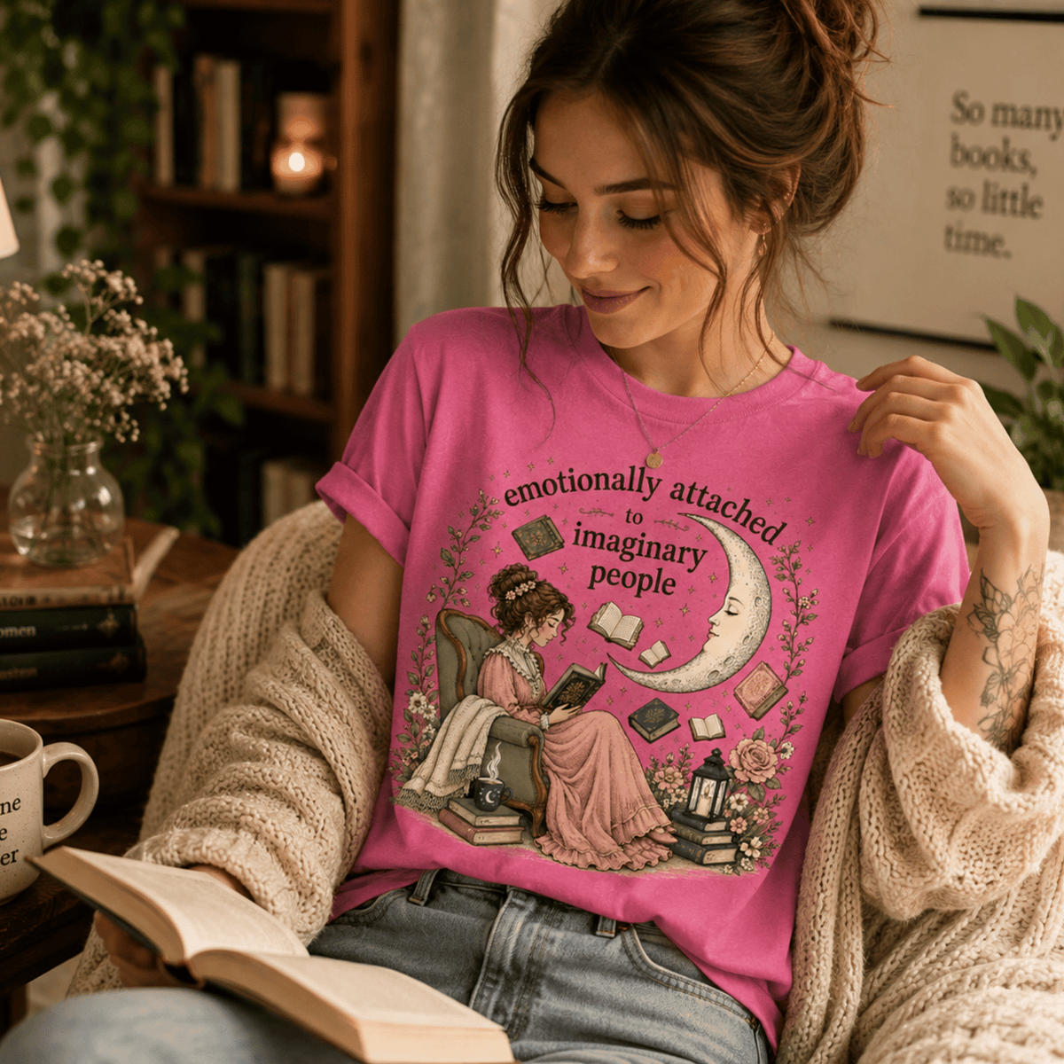 A woman wearing a charity pink Imaginary People cute book graphic t-shirt reading a book.