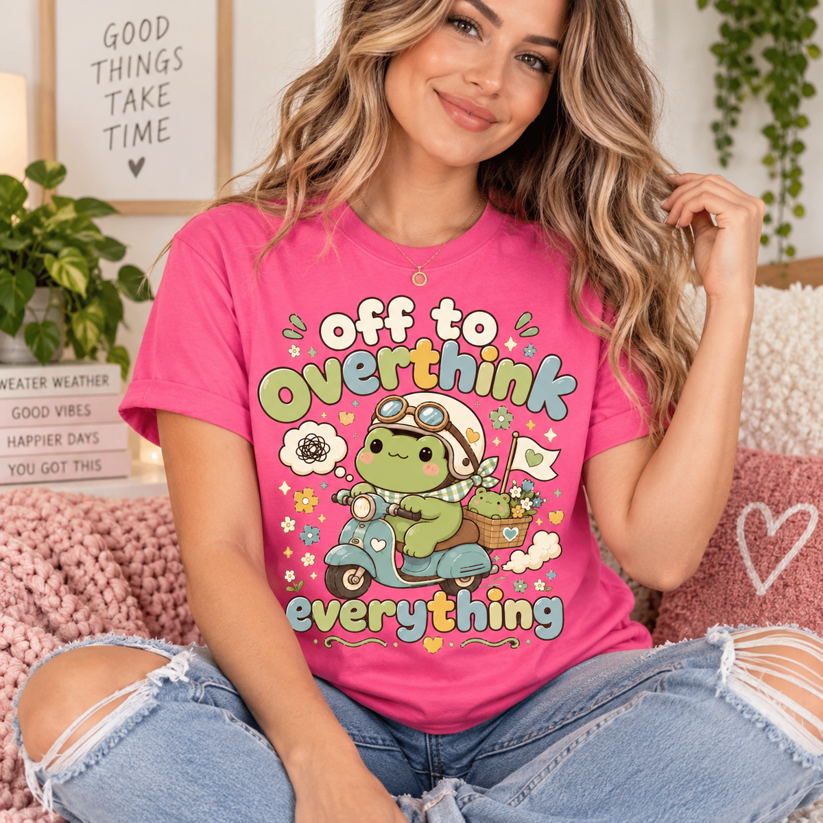 A woman wearing a charity pink Overthink Frog cute animal graphic t-shirt.